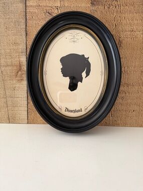Vintage Disneyland Child Silhouette in a Black and Gold Oval Frame